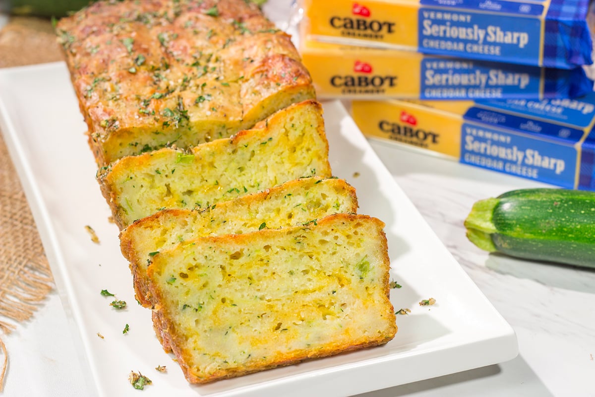 This Cheesy Zucchini Bread is packed with summer flavor! Toast up a slice of this savory quick bread and serve it next to salad or soup for an easy meal.