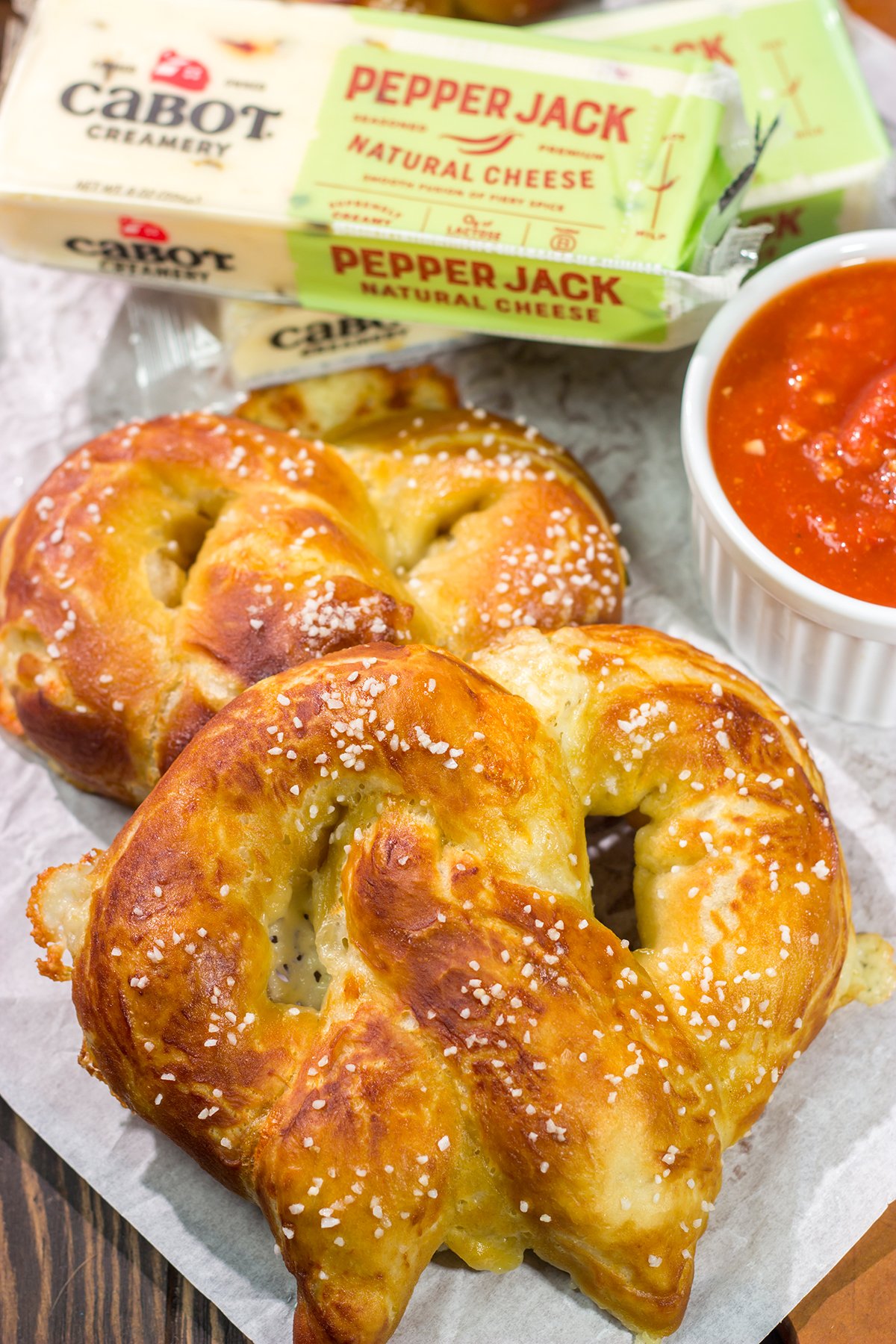 These Cheesy Soft Pretzels are stuffed with melty cheese for the ultimate gameday snack. These warm, golden brown pretzels are absolutely irresistible!