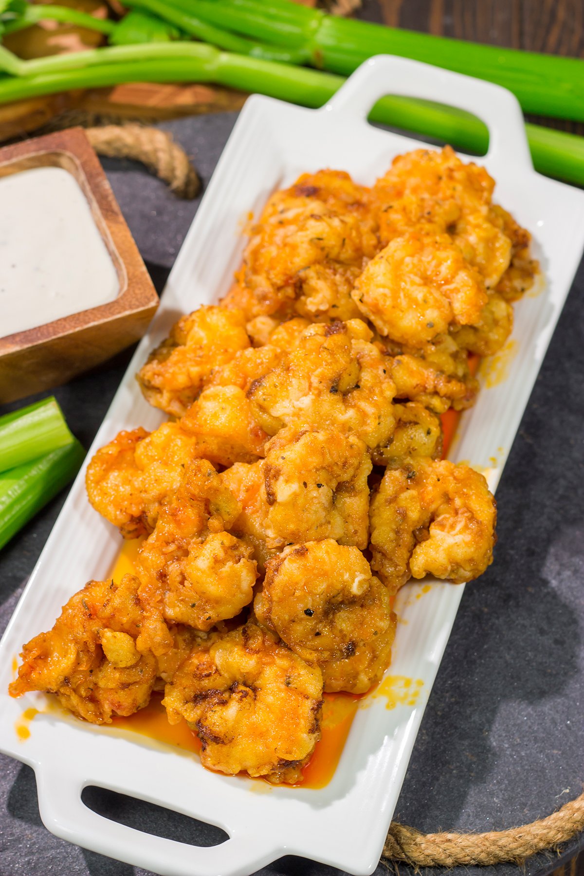 These Fried Buffalo Shrimp are the perfect gameday appetizer! The crispy fried shrimp are tossed in homemade buffalo sauce for maximum flavor.