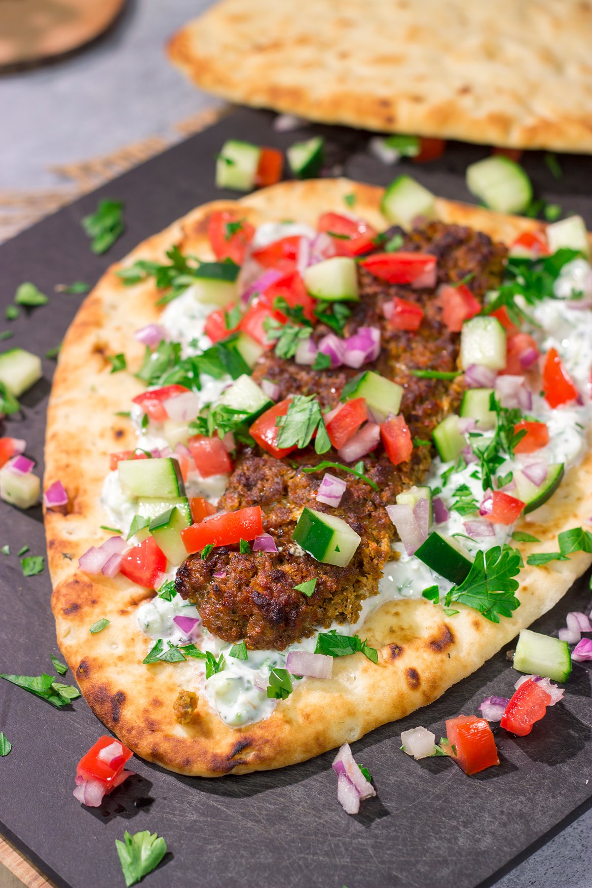 These Sheet Pan Beef Kebabs feature heavily seasoned ground beef served over warm naan. Add in the easy homemade tzatziki sauce, and you've got a delicious dinner plan!