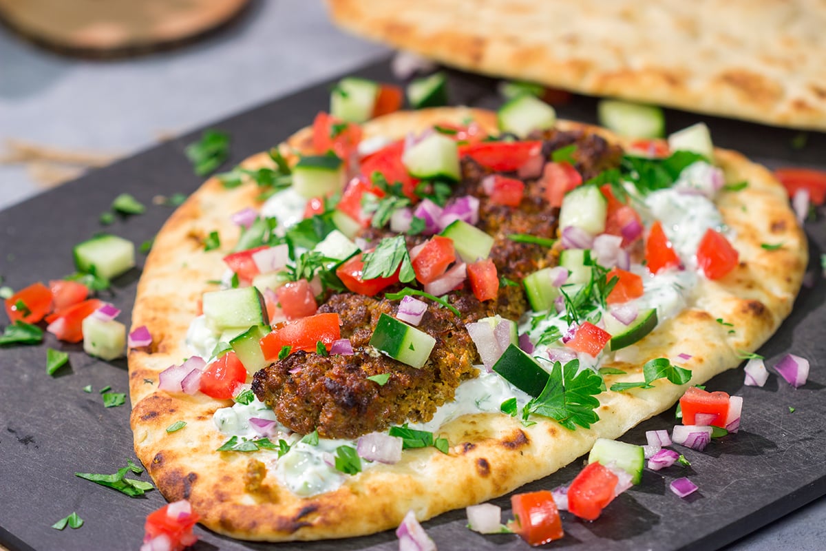 These Sheet Pan Beef Kebabs feature heavily seasoned ground beef served over warm naan. Add in the easy homemade tzatziki sauce, and you've got a delicious dinner plan!