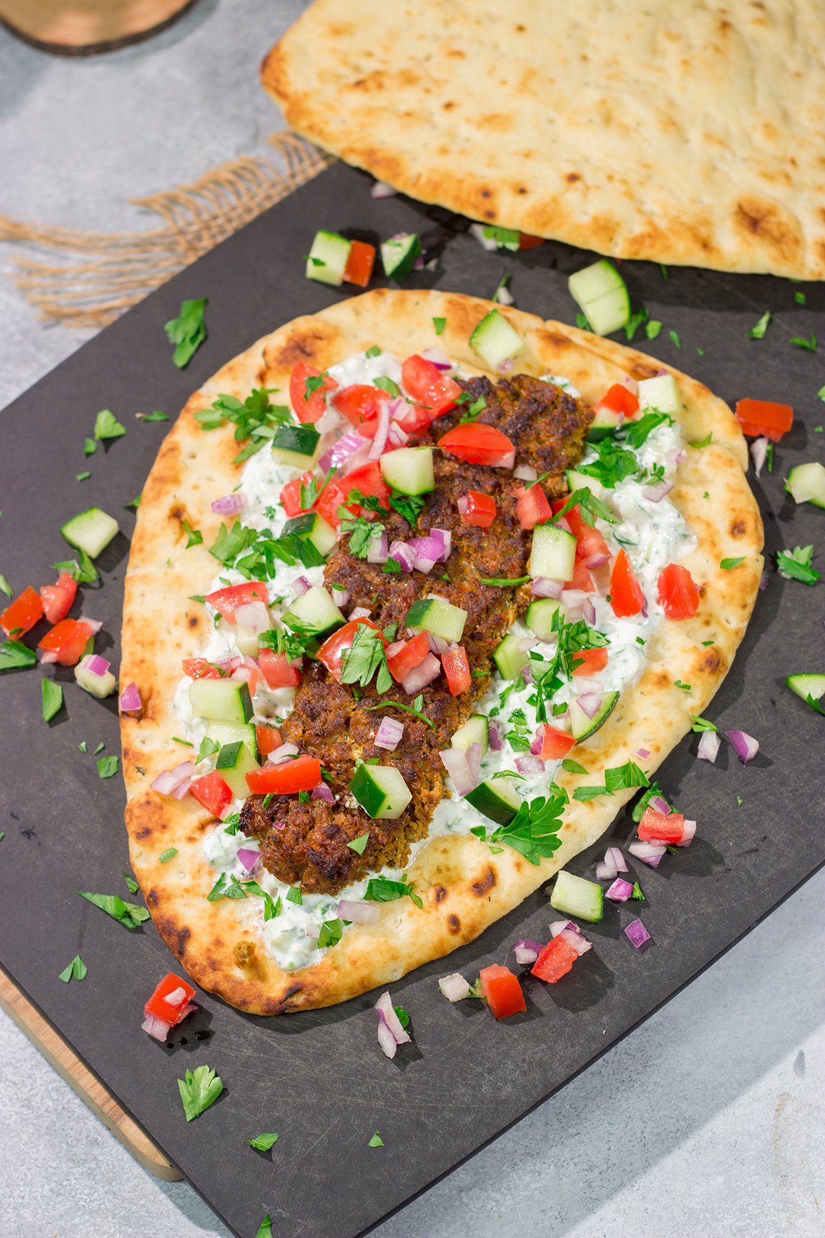 These Sheet Pan Beef Kebabs feature heavily seasoned ground beef served over warm naan. Add in the easy homemade tzatziki sauce, and you've got a delicious dinner plan!
