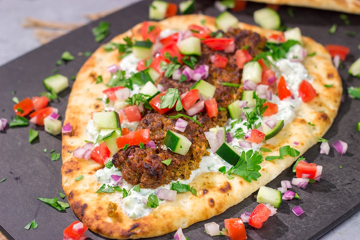 These Sheet Pan Beef Kebabs feature heavily seasoned ground beef served over warm naan. Add in the easy homemade tzatziki sauce, and you've got a delicious dinner plan!