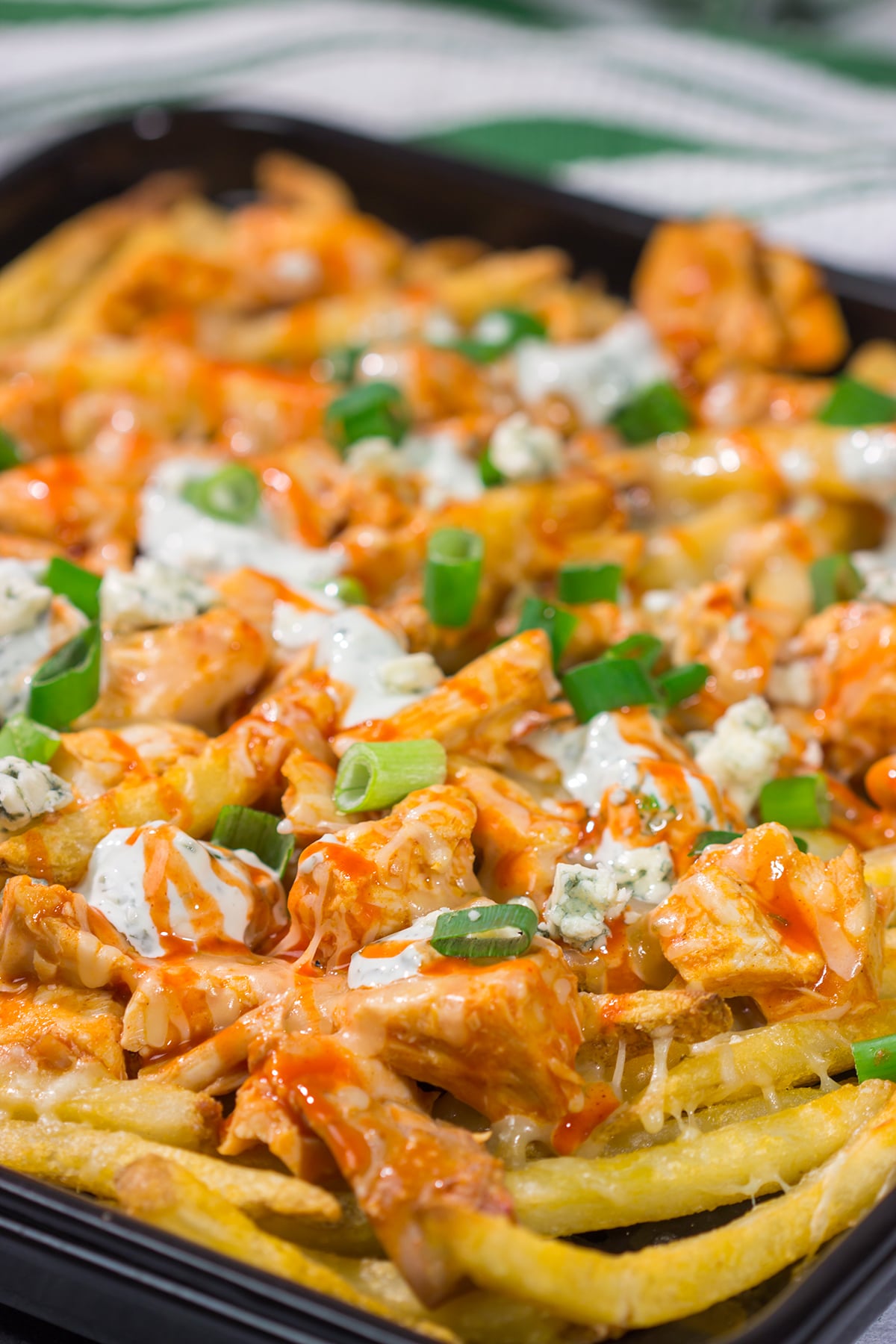 These Buffalo Chicken Cheese Fries are a fantastic gameday appetizer! The kick from the buffalo chicken combined with the creamy blue cheese dressing and melted cheese is a mouthwatering combo.
