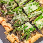 This Cheesy Mushroom Asparagus Tart features flaky puff pastry piled with savory mushrooms, tender asparagus and plenty of melted cheese. It's an easy yet elegant recipe that's perfect for an appetizer or side dish!