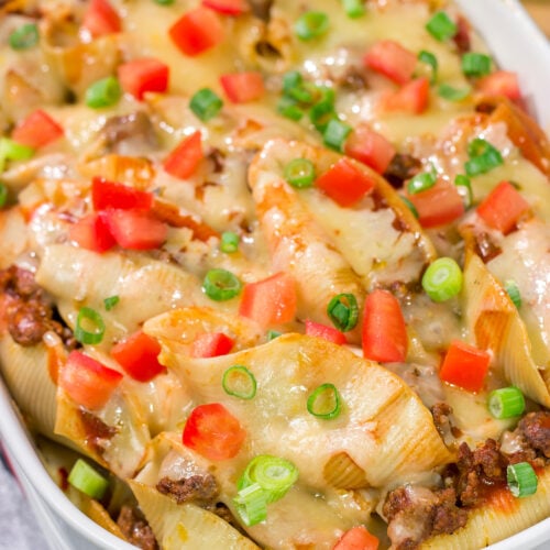 Put a spin on taco night with these Cheesy Taco Stuffed Shells! Instead of tortillas, stuff seasoned taco meat into pasta shells and top it with plenty of melty cheese for a fun family dinner.