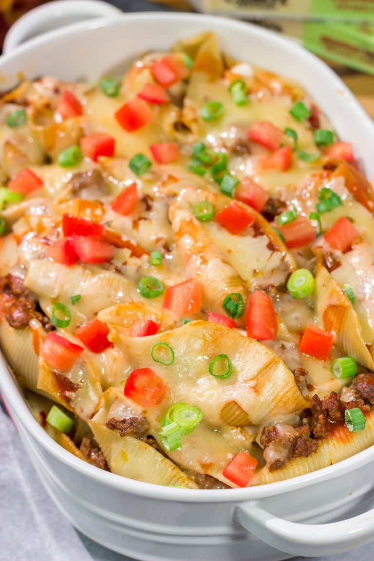 Put a spin on taco night with these Cheesy Taco Stuffed Shells! Instead of tortillas, stuff seasoned taco meat into pasta shells and top it with plenty of melty cheese for a fun family dinner.