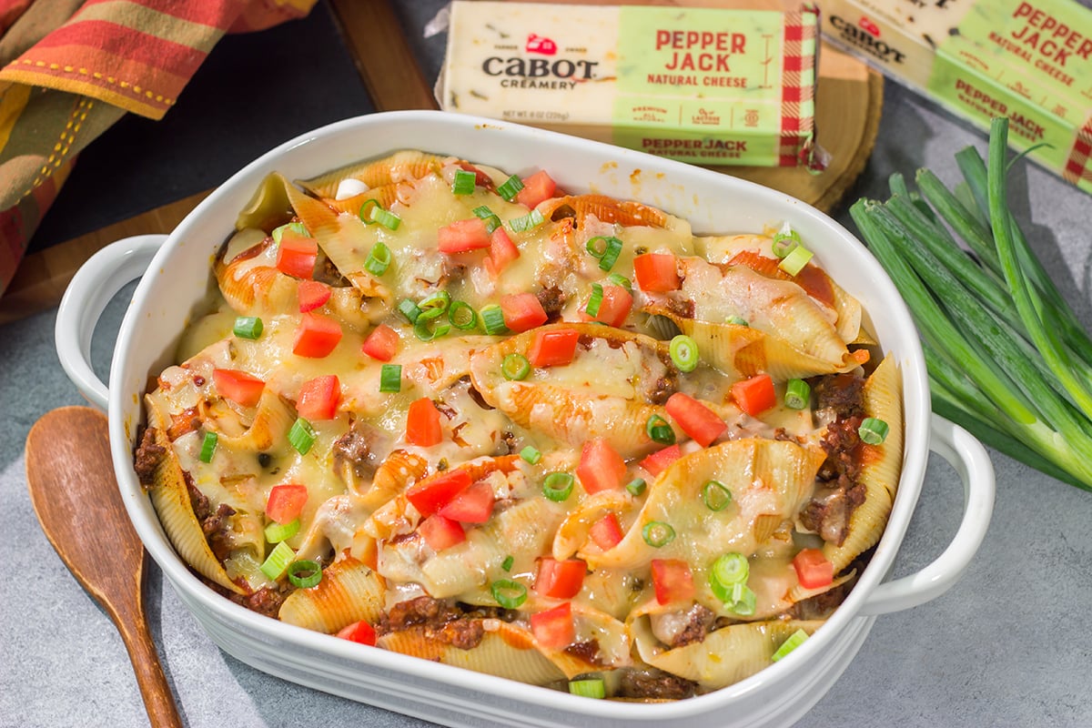 Put a spin on taco night with these Cheesy Taco Stuffed Shells! Instead of tortillas, stuff seasoned taco meat into pasta shells and top it with plenty of melty cheese for a fun family dinner.